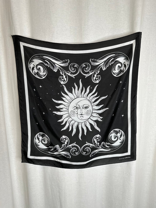 Black square scarf with sun and moon design on a white background